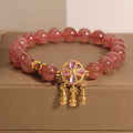 Women's Strawberry Quartz crystal bracelet with a four leaf clover dream catcher ball pendant.