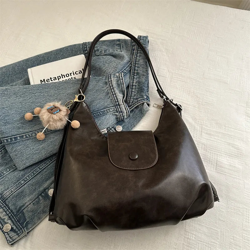 Textured PU leather commuter shoulder backpack in horizontal square shape with single strap and mobile phone compartment