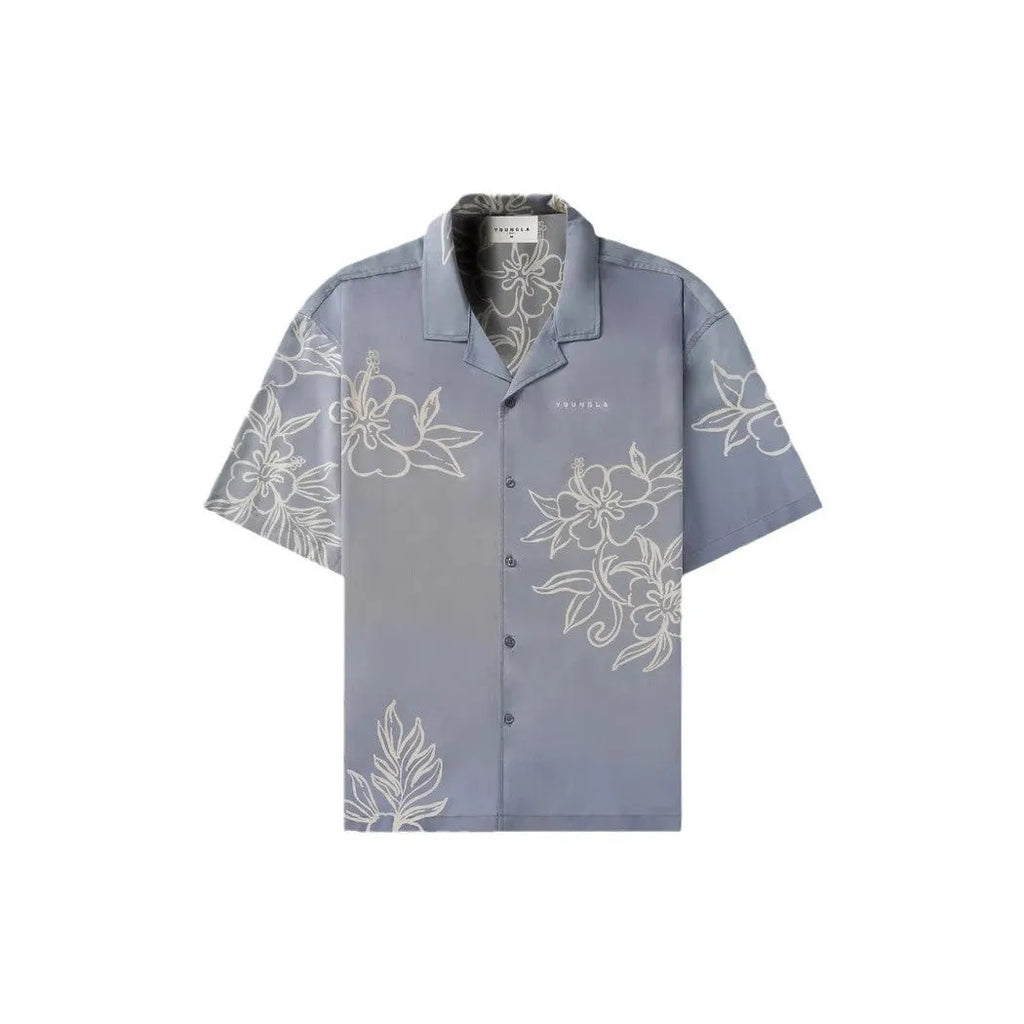 Man wearing a loose, short-sleeve printed cardigan top in a floral pattern.