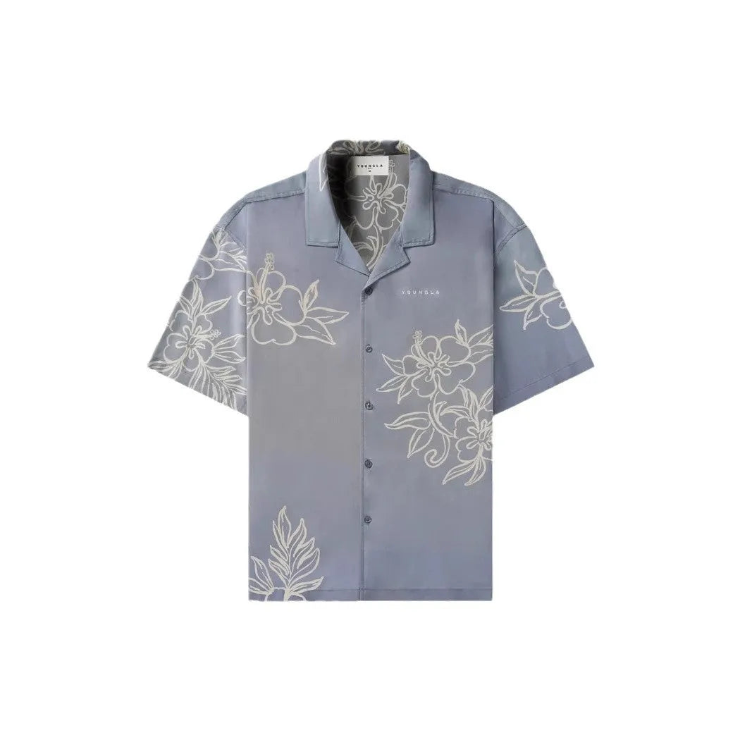 Man wearing a loose, short-sleeve printed cardigan top in a floral pattern.