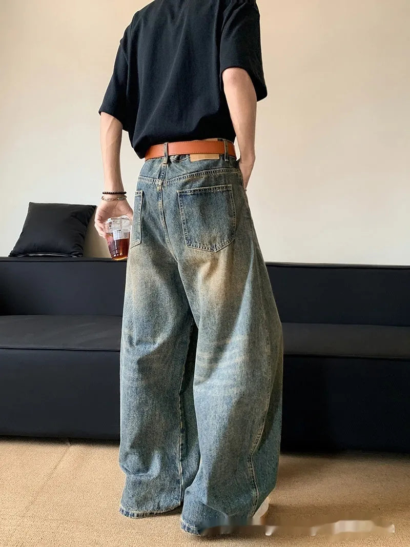Men's retro blue distressed machete denim jeans with wide-leg silhouette and slim hip fit