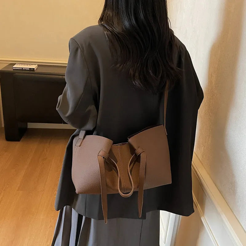 Large capacity one-shoulder crossbody bag in soft PU with sewing line detail, available in black, brown, coffee, gray
