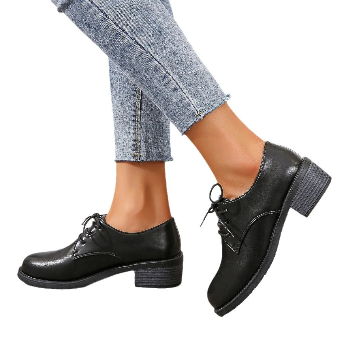 Black women's low-top work shoes with a chunky rubber heel and pointed toe.