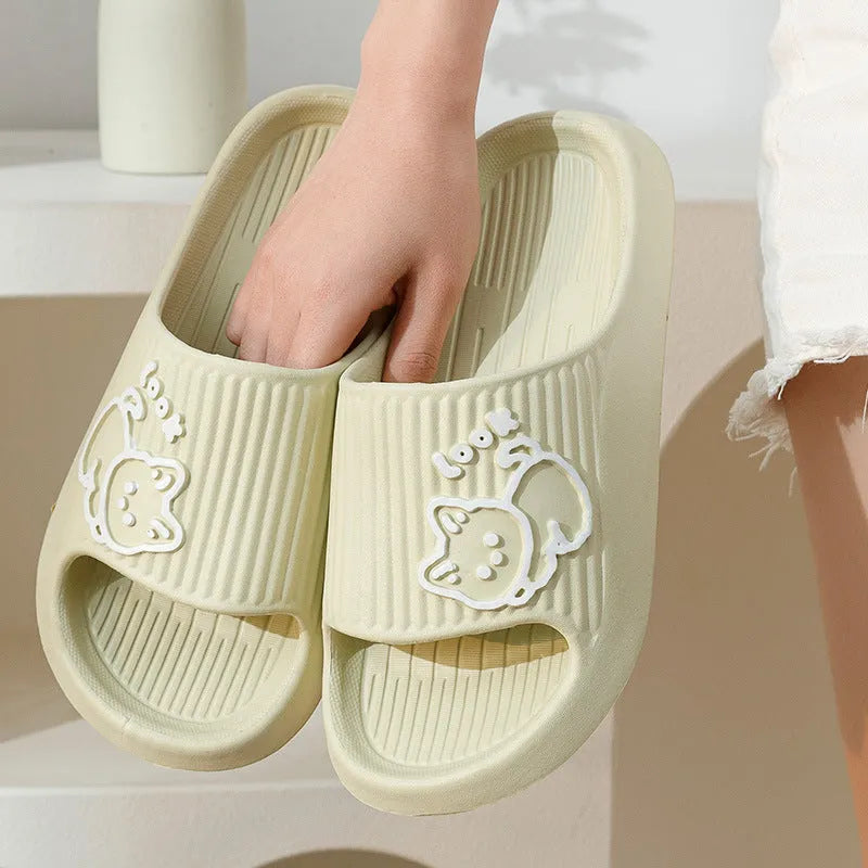 Women's green cat slippers with thick EVA platform sole on a wooden floor