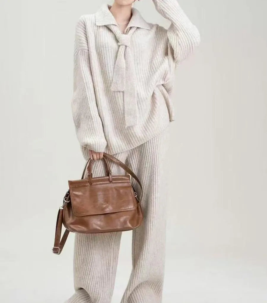 Beige imitation cashmere sweater suit two-piece set with knit top and trousers on a hanger