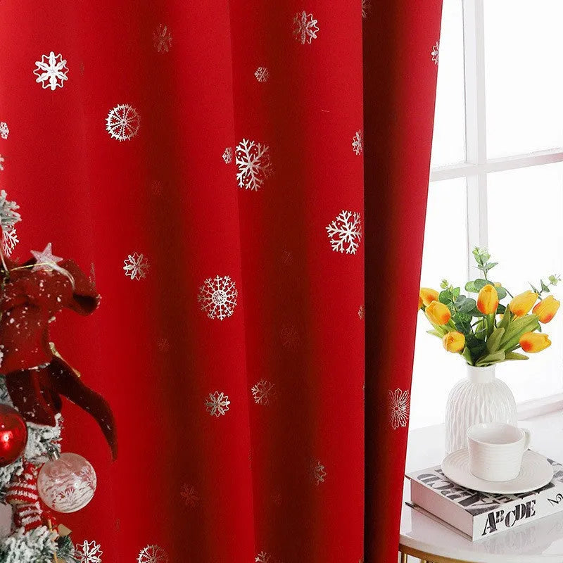 Red snowflake pattern shade cloth curtain with iron hoop hanging tabs.