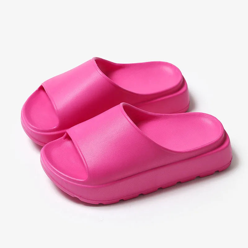 Women's beige fish mouth slippers with a thick 5.5cm EVA platform sole on a wooden floor.