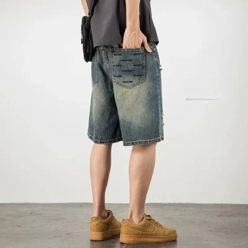 Blue retro loose hole denim shorts for men on a white background