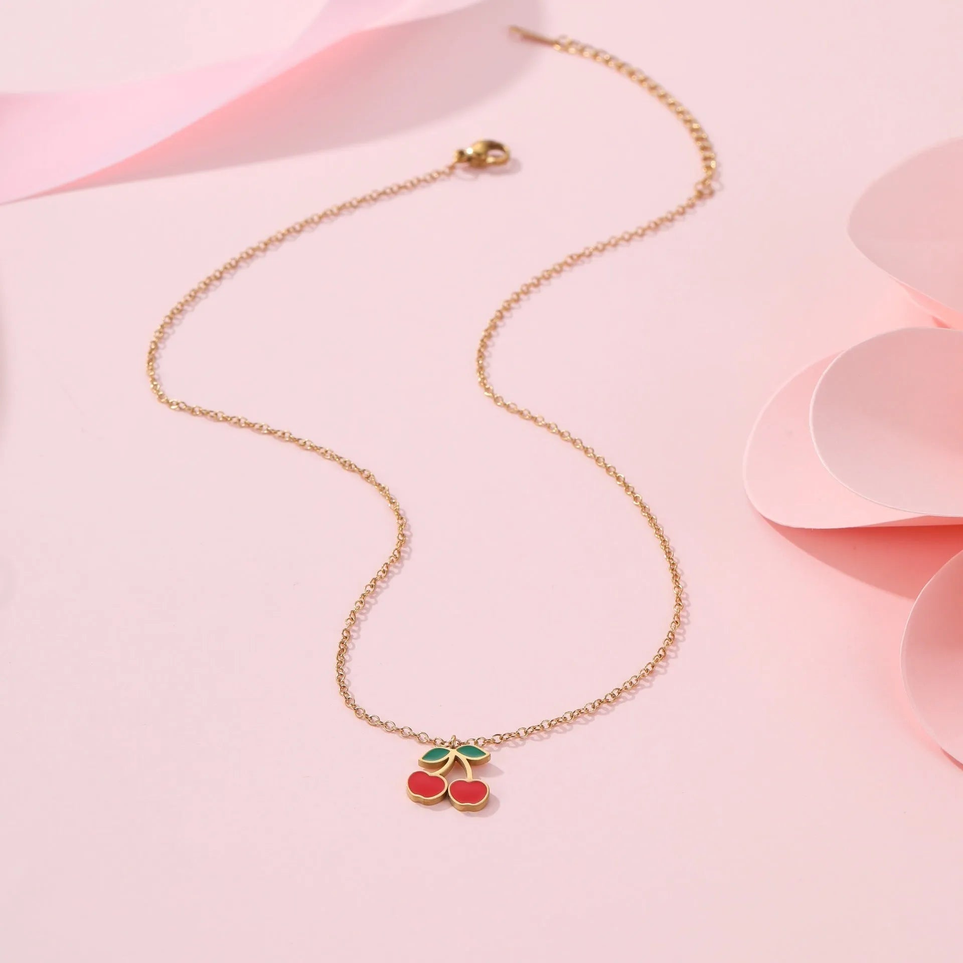 Stainless steel cherry jewellery set with necklace, bracelet, earrings, and ring in golden electroplated finish