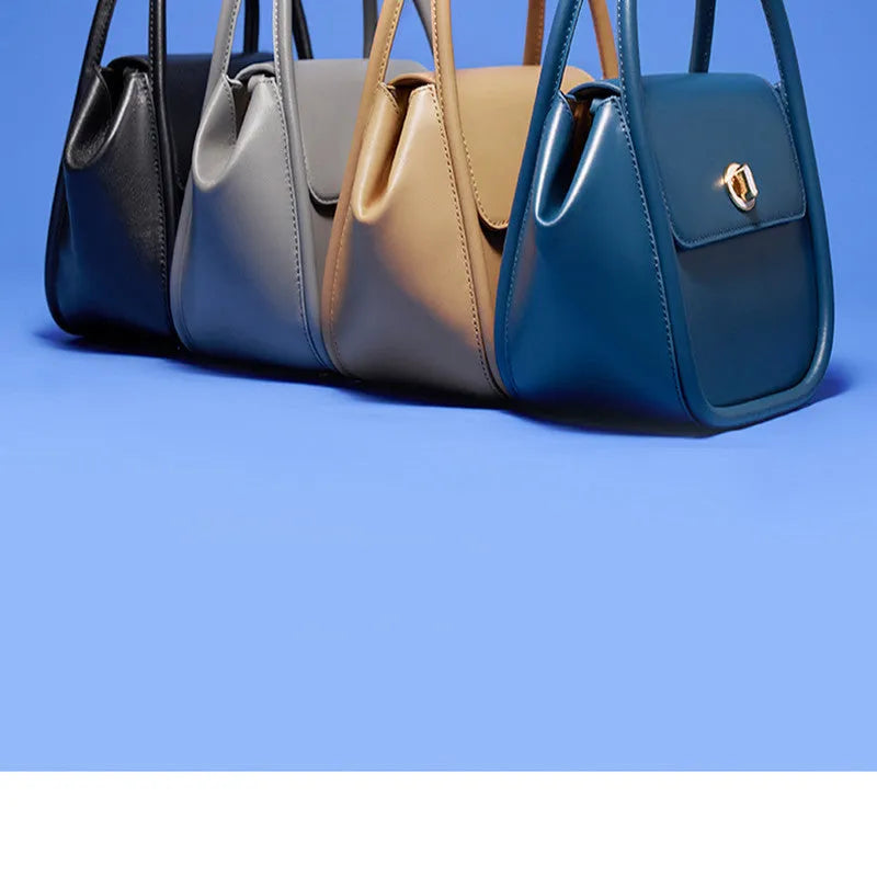 Women's leather wing tote handbag with cross-body strap and hard handle in cow leather