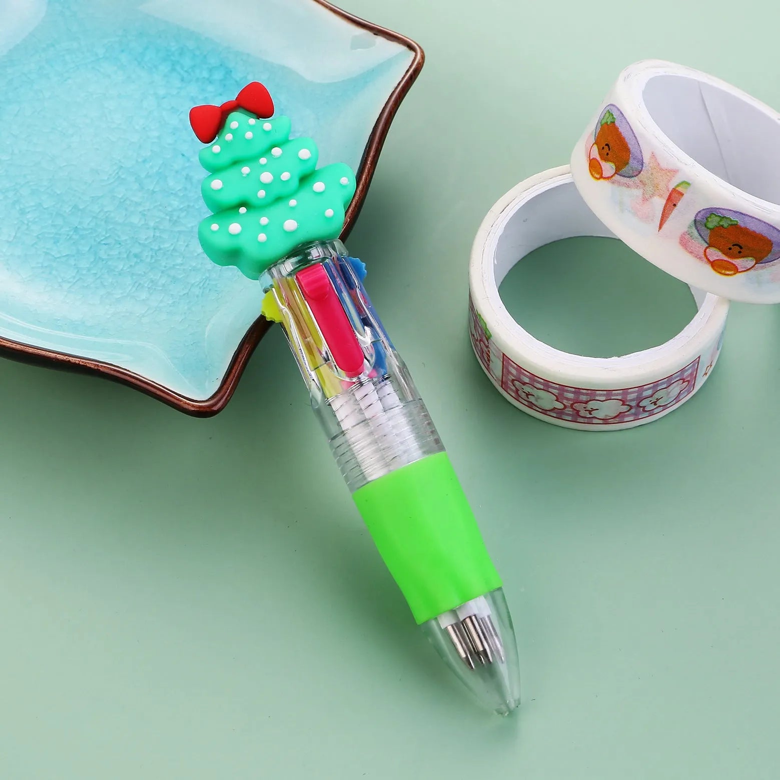 Christmas mini four-colour press-type ballpoint pen showing festive designs, 11cm long.