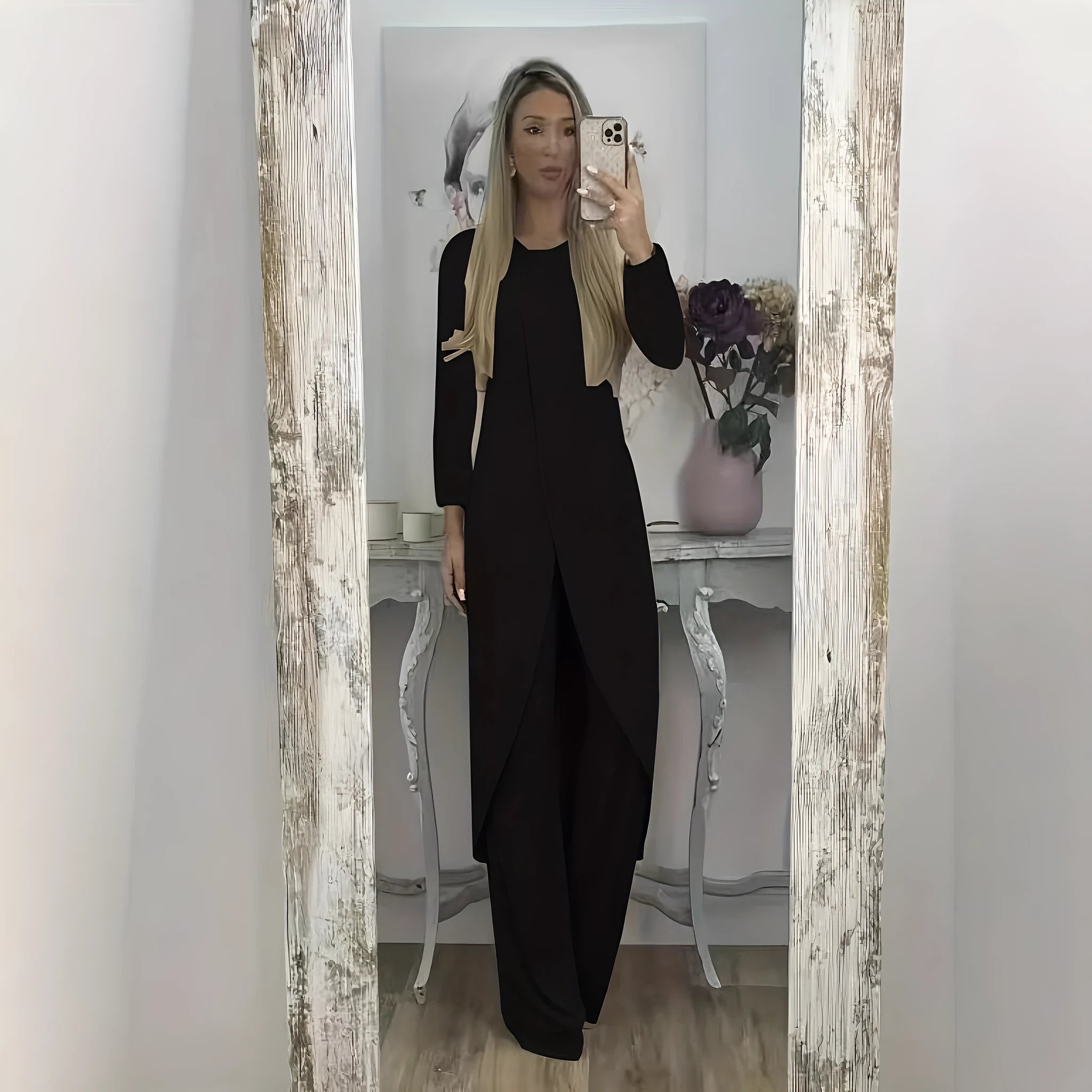 Casual long sleeve polyester two-piece lounge set in black, shown with loose round neck top and trousers.