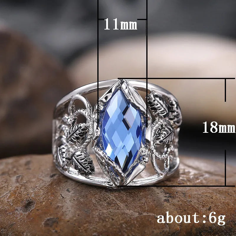 Blue crystal inlaid in a geometric horse eye shape on an alloy women's ring.