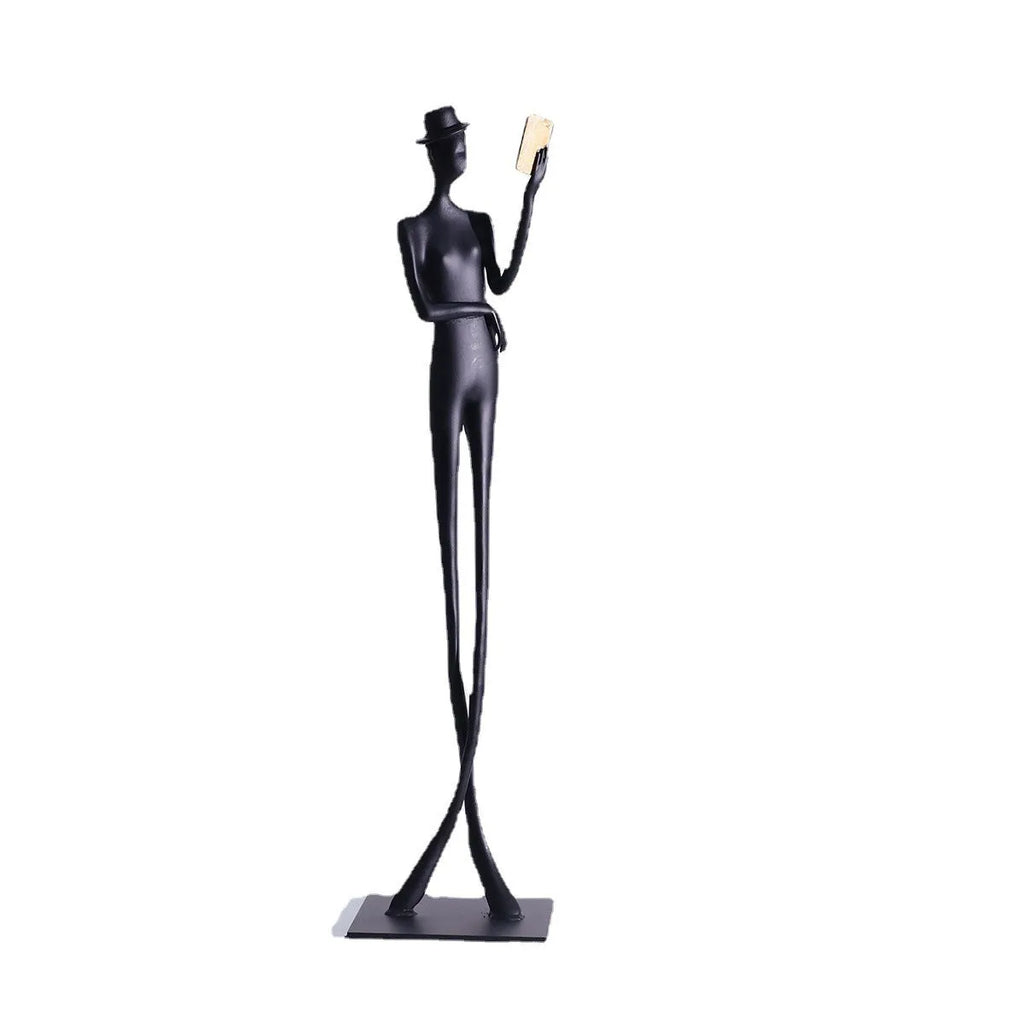 Black aluminium reading woman desk sculpture measuring 12cm by 12cm by 51cm