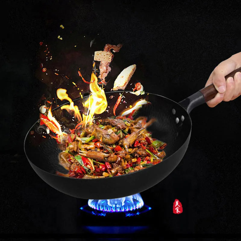 Traditional black iron wok with long wooden handle measuring 32cm diameter