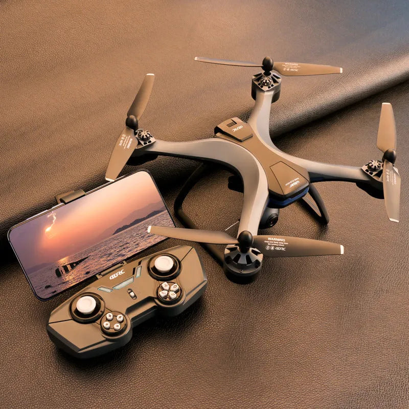 Plastic quadrocopter drone with four rotors and GPS antenna, shown with handle remote controller and spare blades