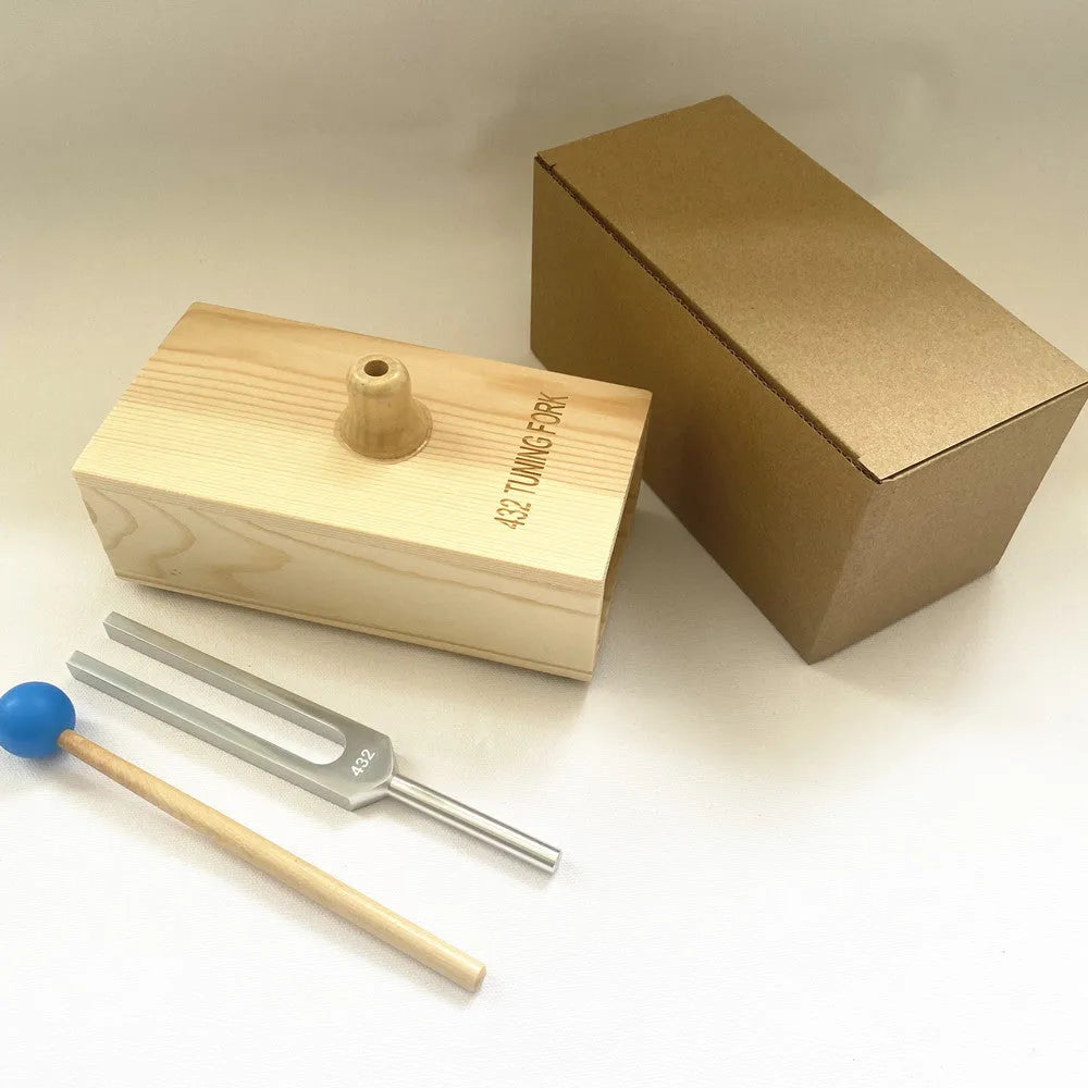 Aluminium alloy 432Hz tuning fork with speaker on kraft paper box background