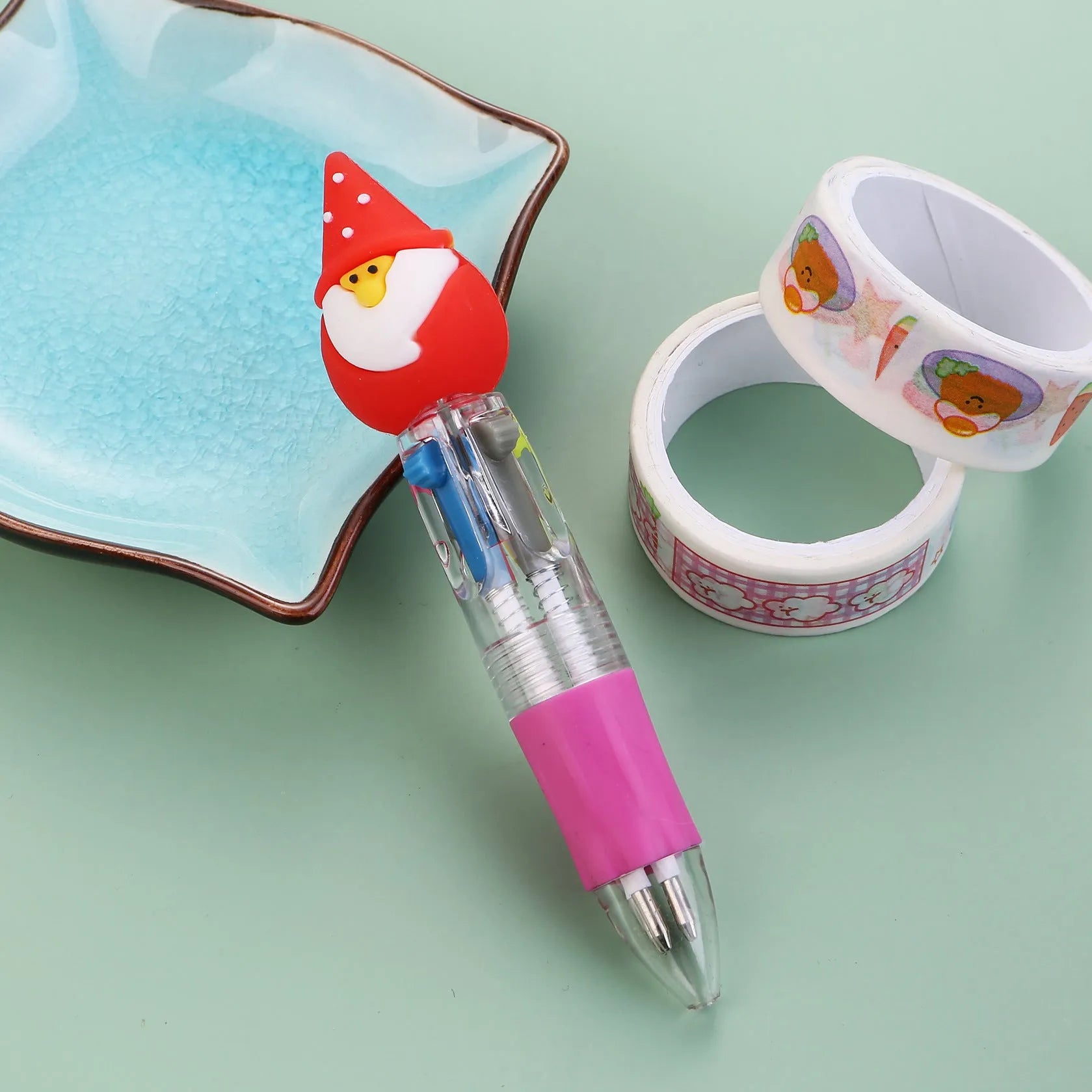 Christmas mini four-colour press-type ballpoint pen showing festive designs, 11cm long.