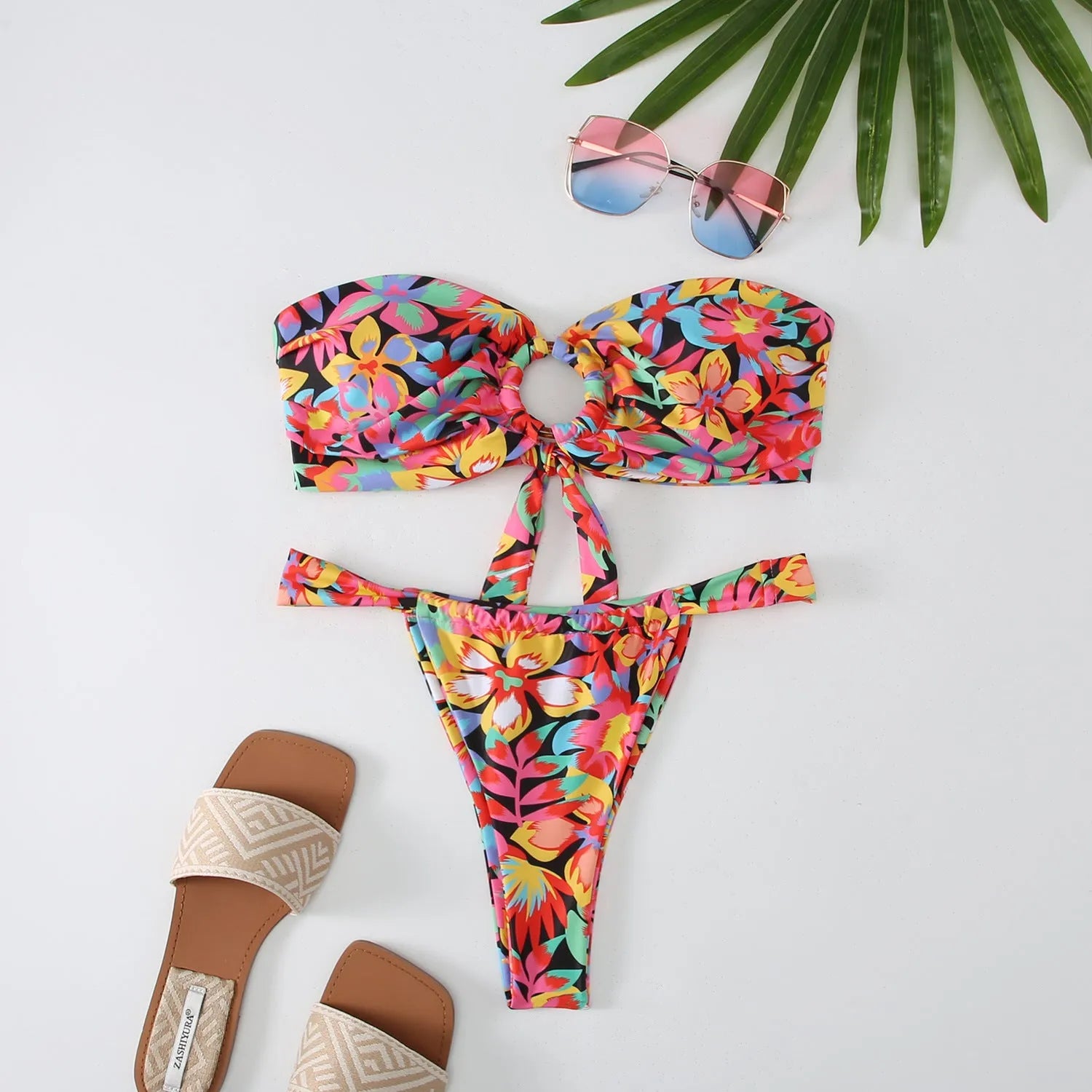 Women's floral printed tube top ring bikini swimsuit on a neutral background.