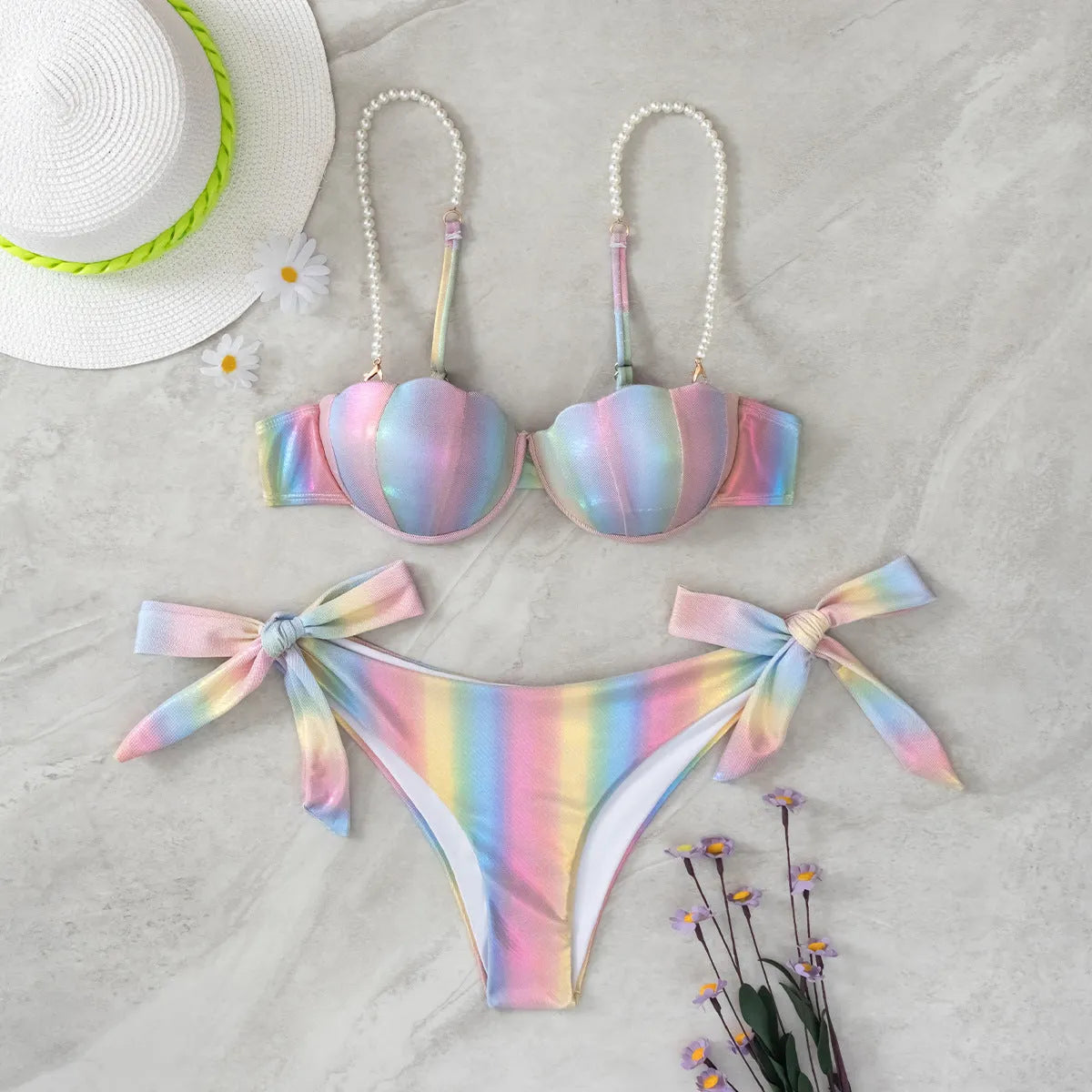 Women's rainbow coloured split tied bikini swimsuit set on a mannequin.
