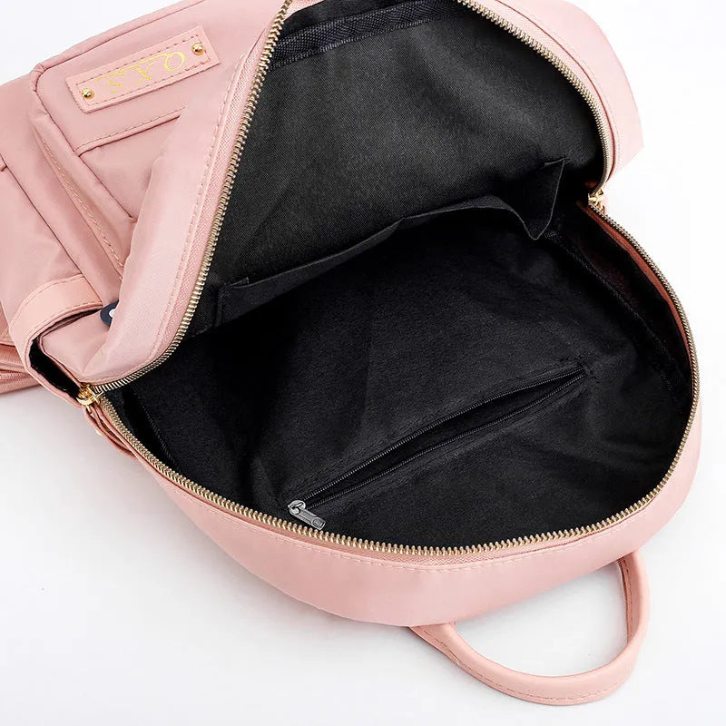 Women's black nylon backpack with square vertical shape showing internal compartments and shoulder straps