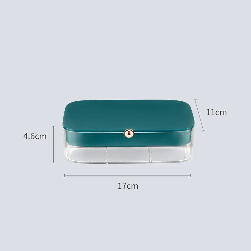 Modern minimalist green jewellery storage box with multi-layer compartments open on a dressing table.