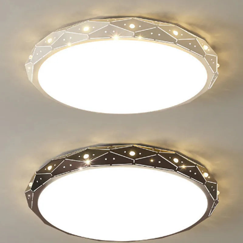 Round flush mount LED ceiling light with black iron frame on a white ceiling.
