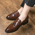 Men's black slip-on loafers with tassel detail and rubber sole for business casual wear