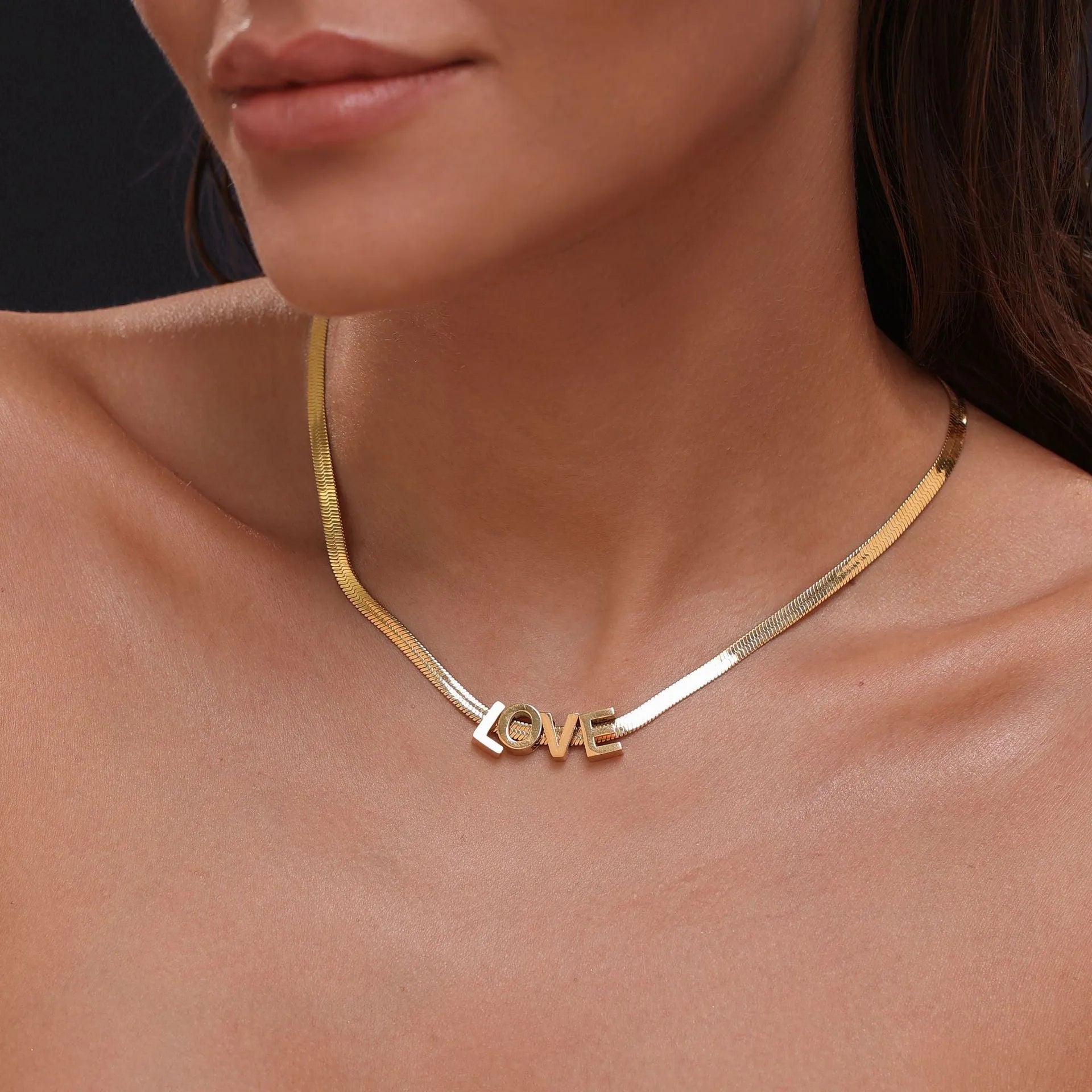 Gold titanium steel necklace with letter A charm on a 40.5cm chain.