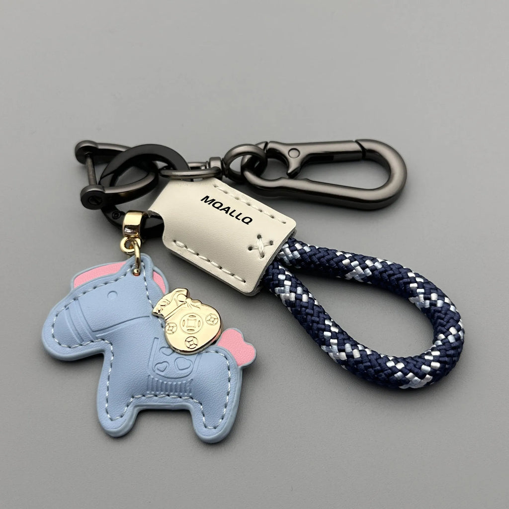 Handmade brown cowhide key pendant with a green flannel rope and a gold-toned horse-shaped buckle.
