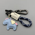 Handmade brown cowhide key pendant with a green flannel rope and a gold-toned horse-shaped buckle.