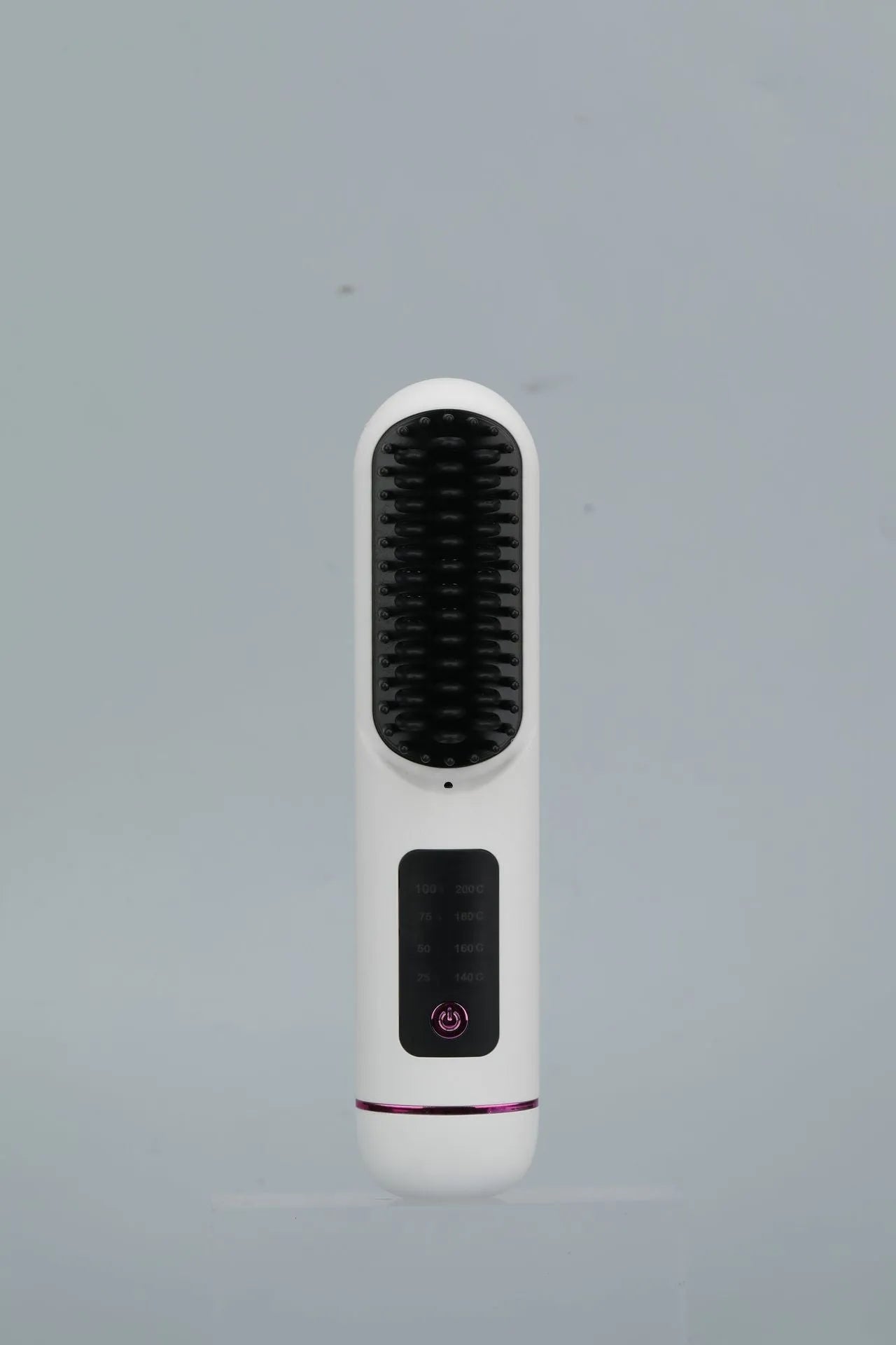 White portable negative ion hair comb with rechargeable battery on a plain background.
