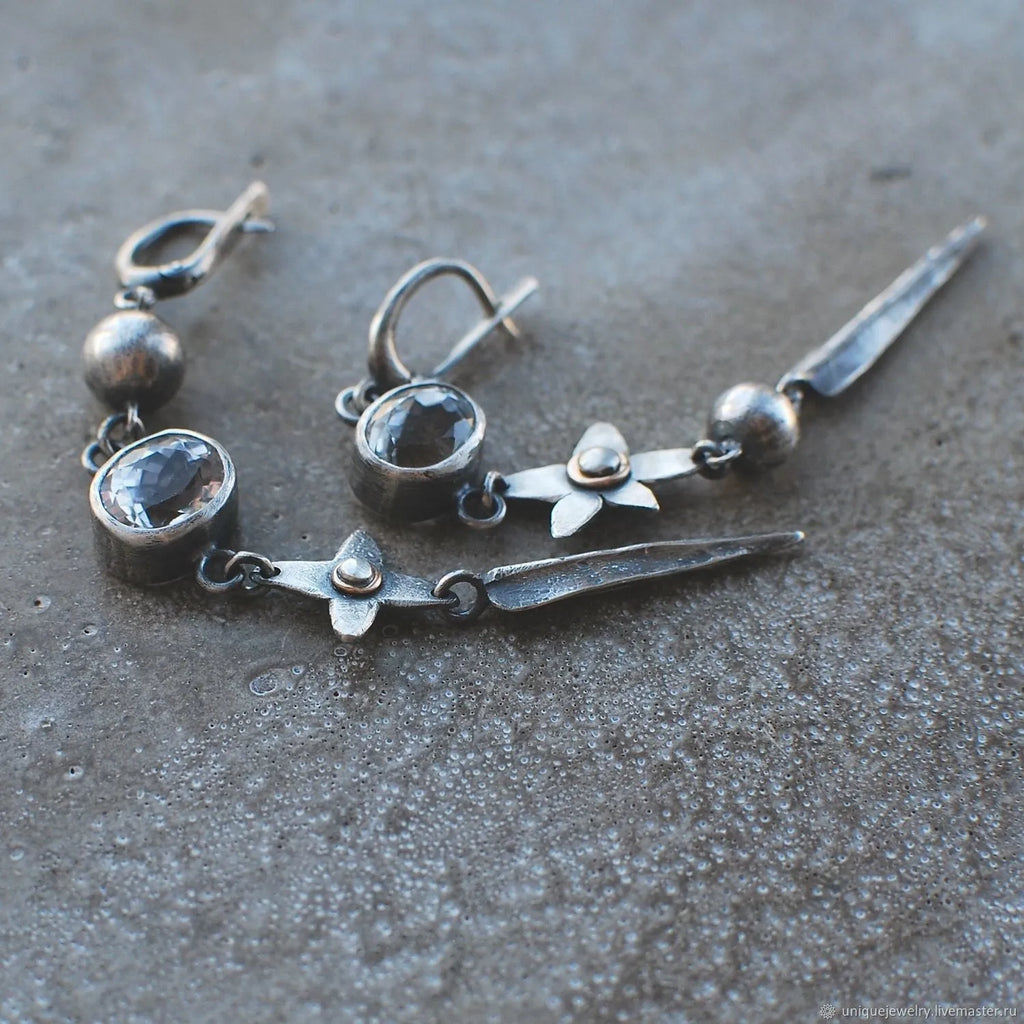 Geometric antique silver long drop earrings with rhinestones and a XINGX design motif.