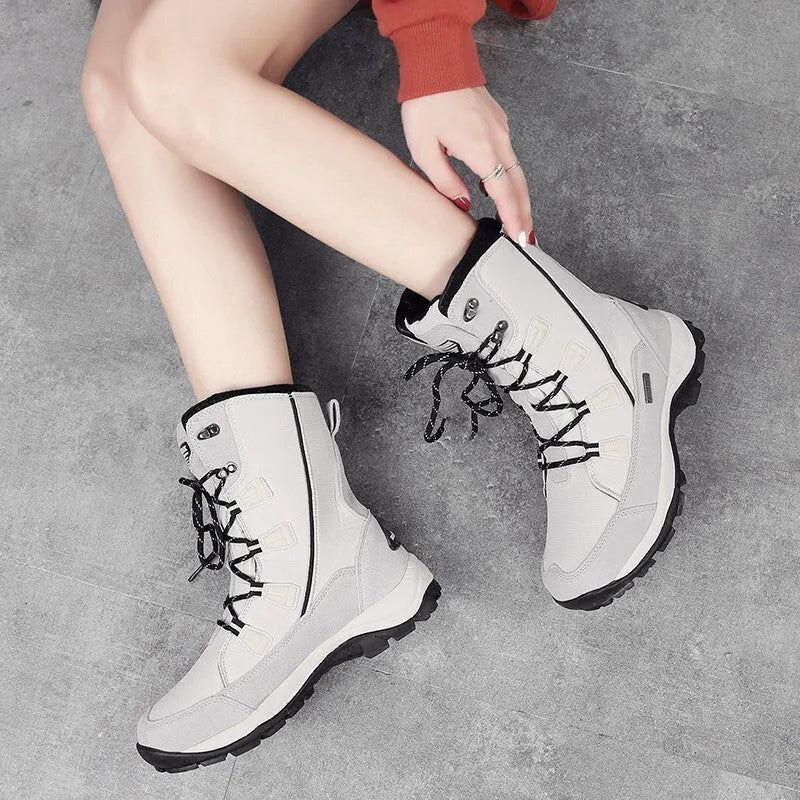 Women's black genuine leather mid-calf snow boots with a round toe and rubber sole on a white background.