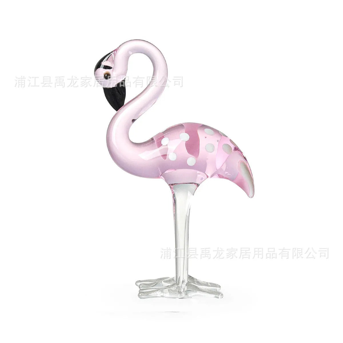 White crystal flamingo decorative ornaments with pink dots on a table