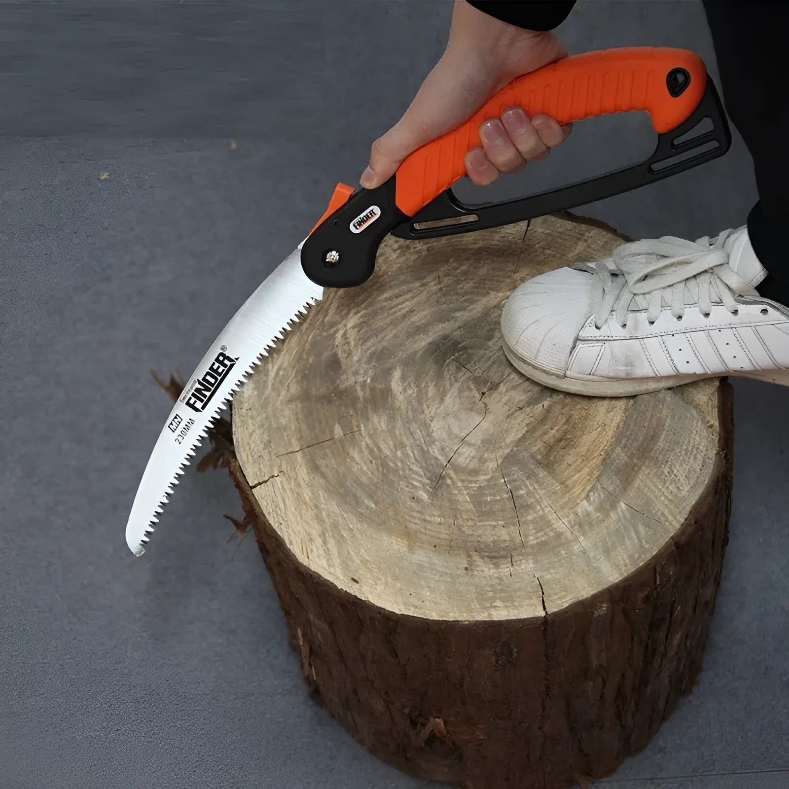 Folding garden saw with extended 230mm blade showing teeth detail and TPR grip handle
