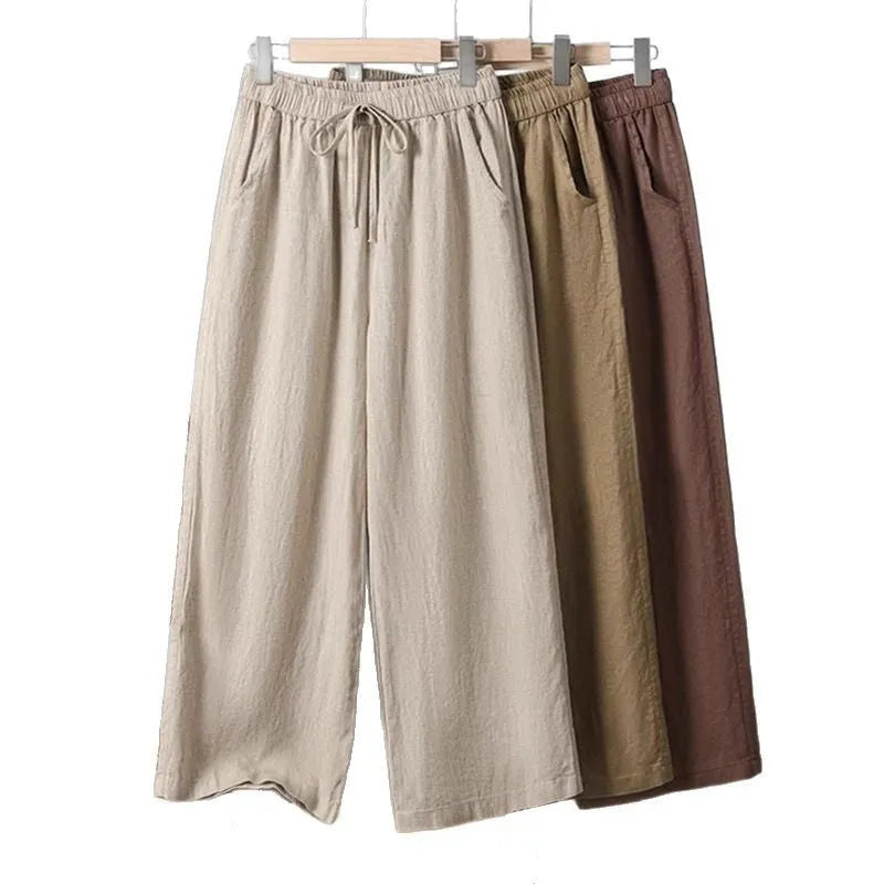 Women's straight leg casual trousers in khaki with an elastic waistband and lace-up drawstring detail.