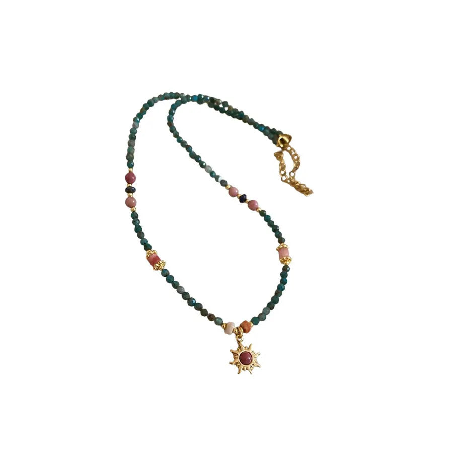 Freshwater pearl necklace with stone sun pendant on adjustable clavicle chain in blue and golden pink colours