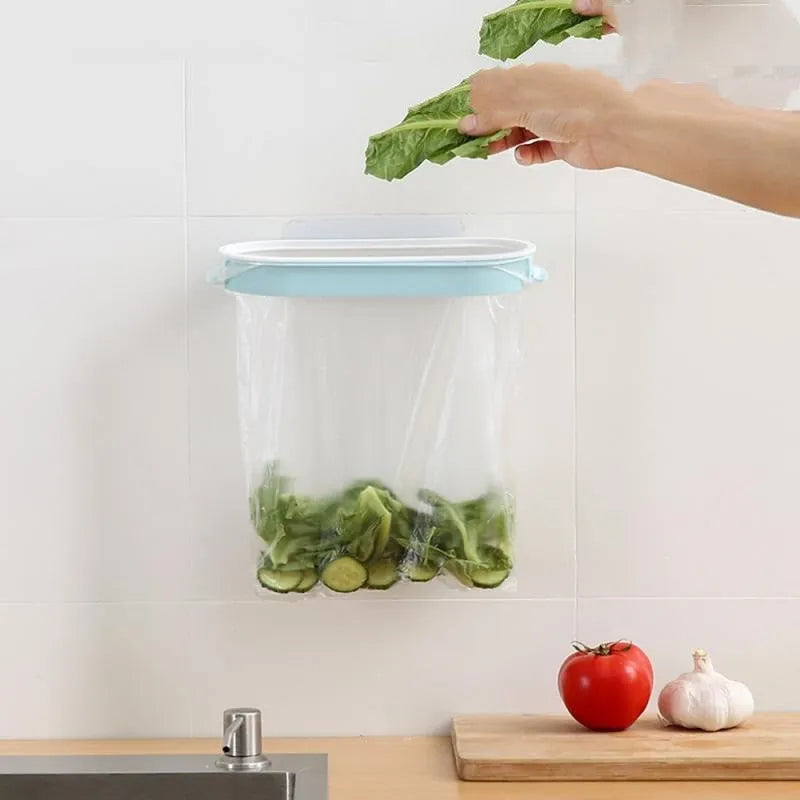 A blue plastic garbage bag storage rack mounted inside a kitchen cabinet door.