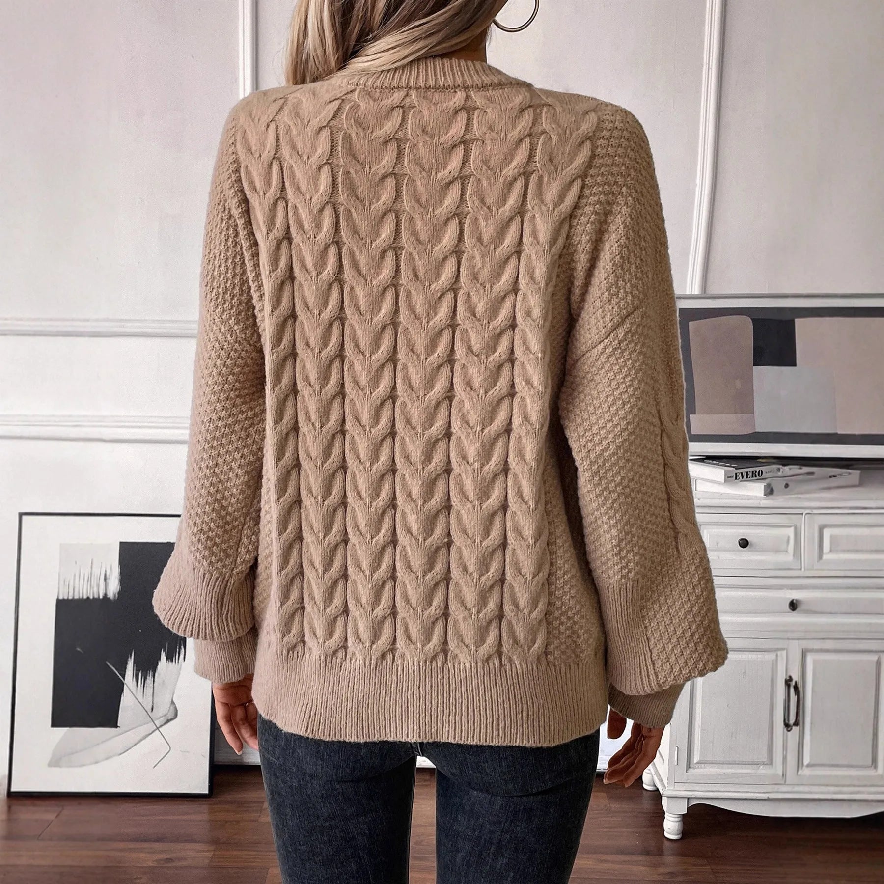 Women's beige loose sweater with round neck and twisted yarn detail on solid polyester fabric