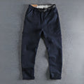 Man's khaki cotton canvas work trousers with 3D cut, showing mid-rise waist and zipper fly.