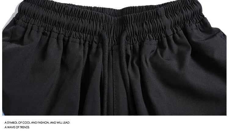 Black and grey quick-drying sports shorts with elastic waistband and loose straight-leg design
