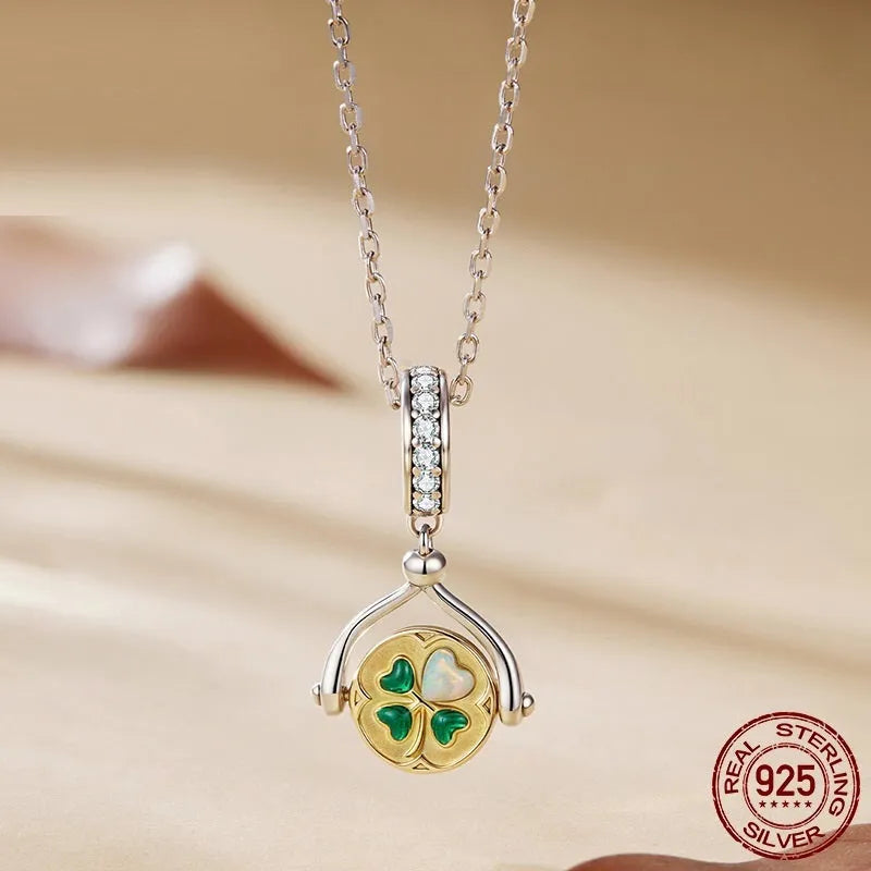 925 sterling silver rotating card pendant with four-leaf clover and wing detail on white background