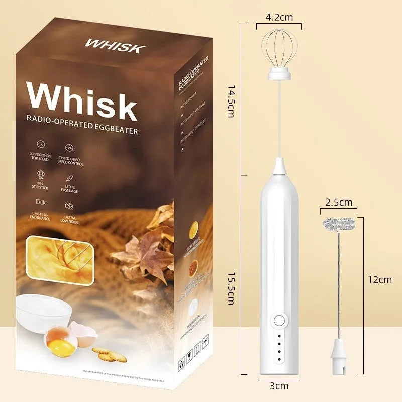 Compact black handheld milk frother with stainless steel whisk on a kitchen counter.
