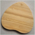 Square brown bamboo 5W wireless charging pad on a wooden table