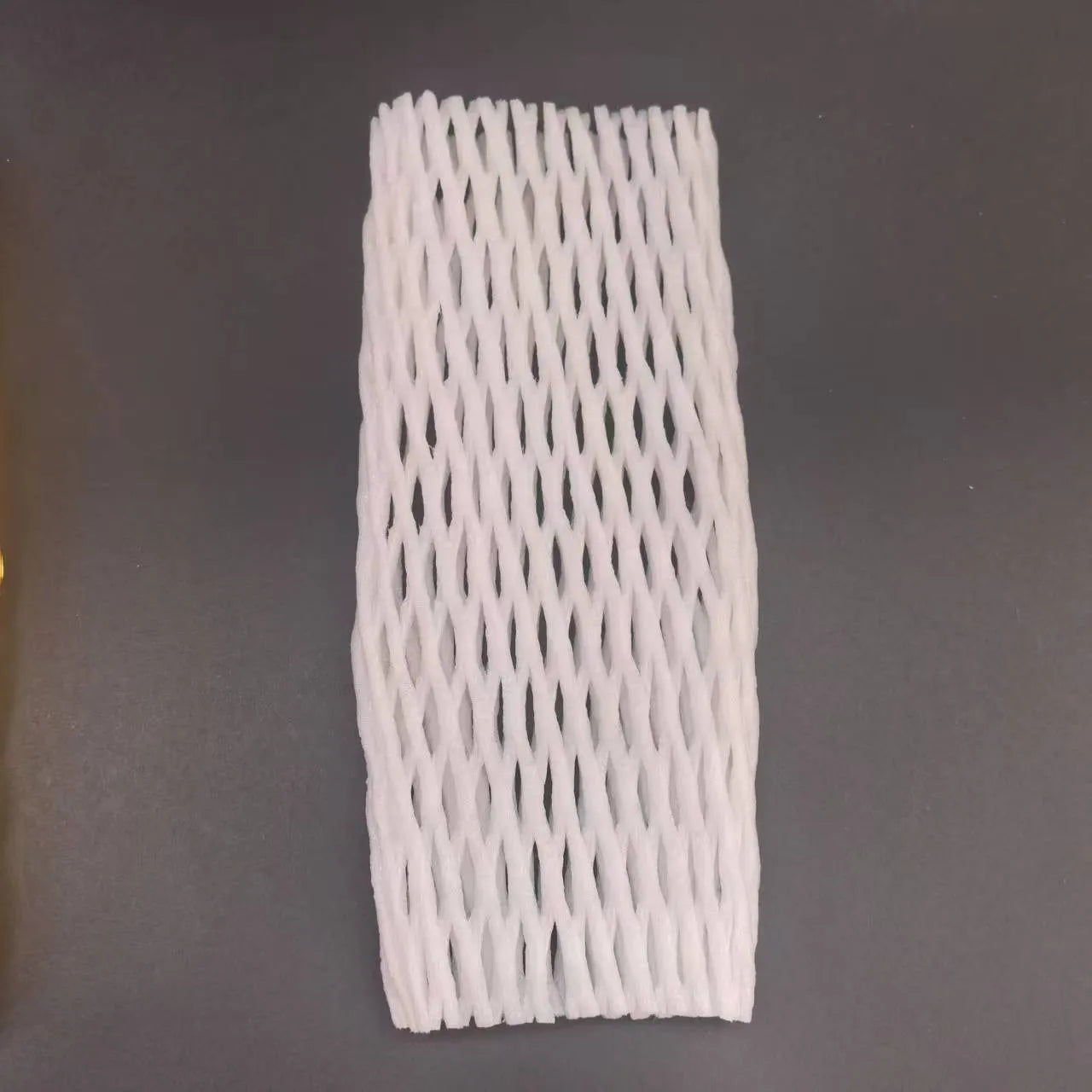 White foam net cover for fruit protection shown in various sizes on a table.