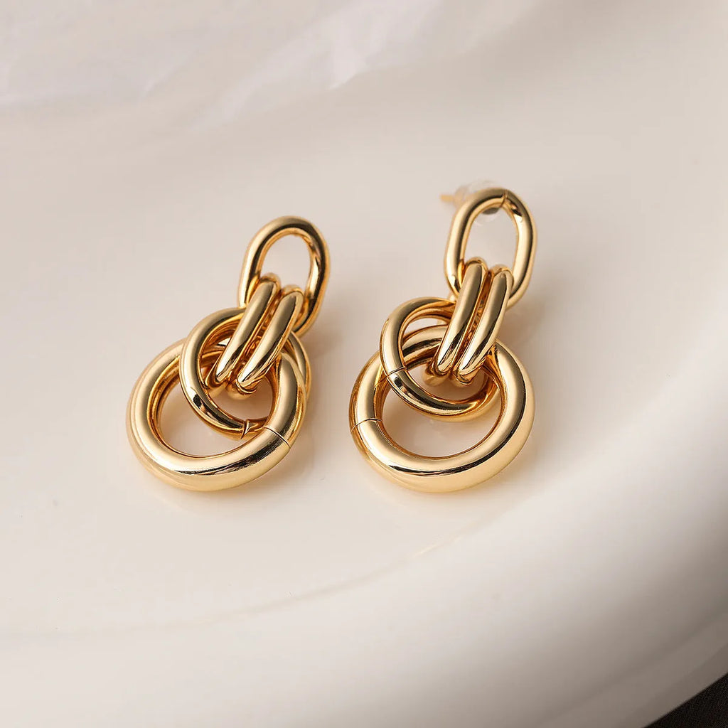 Gold geometric earrings with irregular asymmetric design and INS high-profile styling