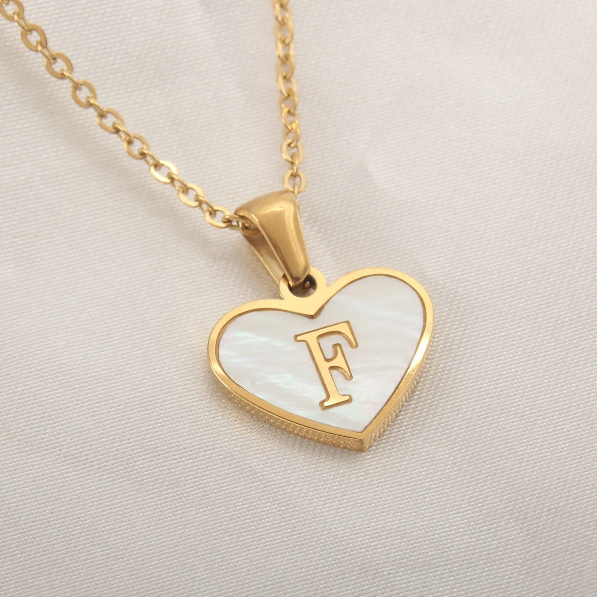 Gold heart necklace with white shell pendant and initial charm on 45cm adjustable chain