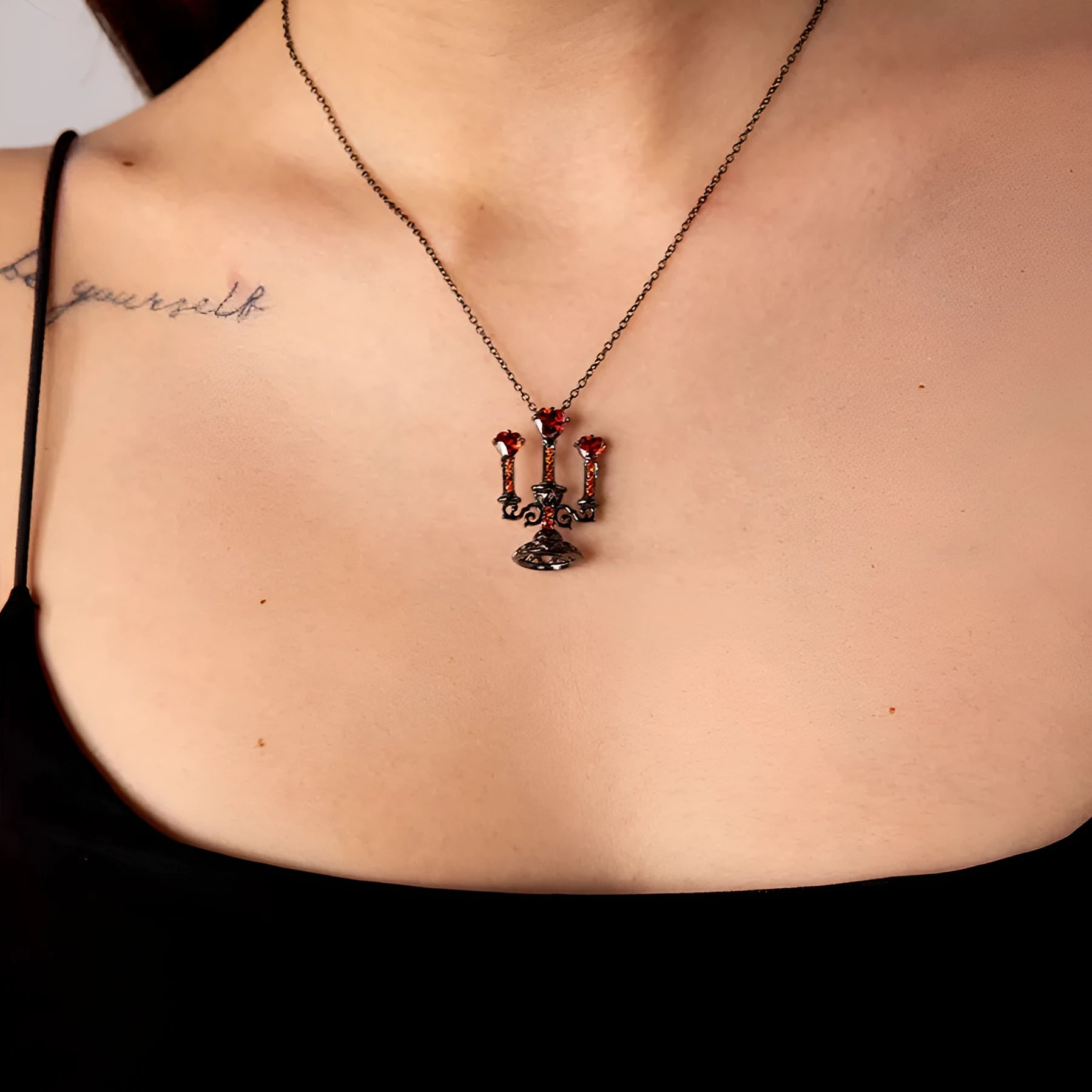 Gothic style zinc alloy clavicle chain necklace with a hollow candlestick pendant on a cross chain.