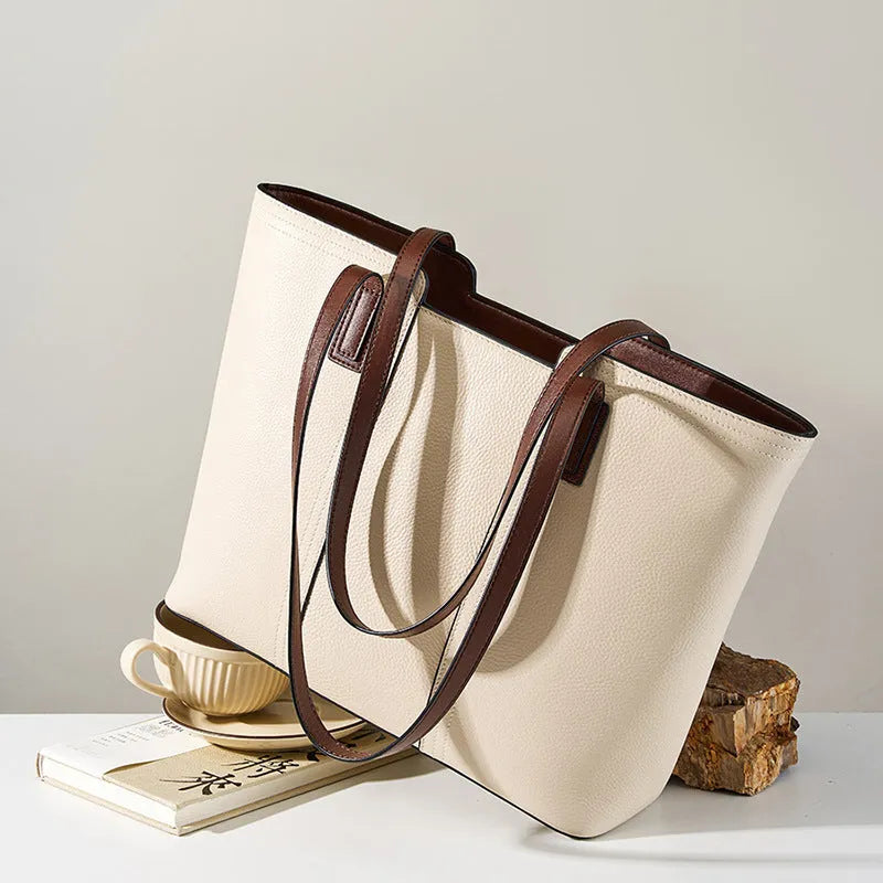 Black genuine leather women's shoulder bag showing multiple internal compartments and single strap